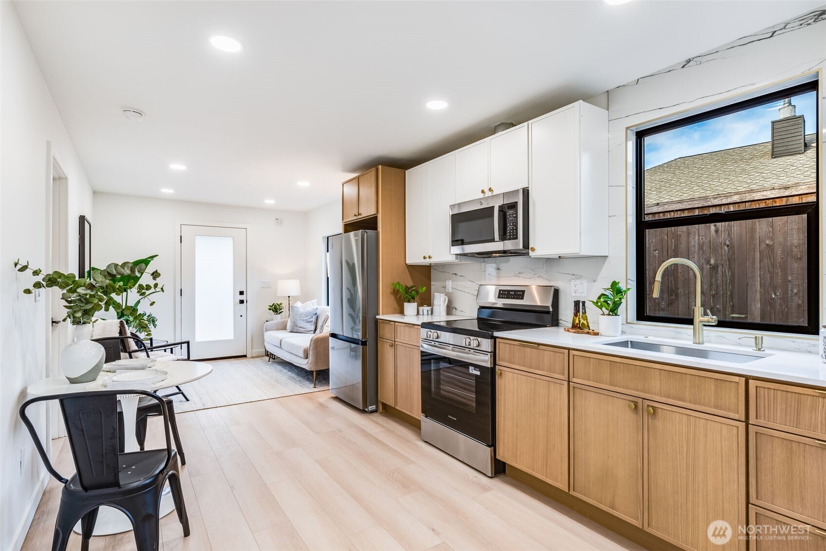 4922 Northeast 20th Place Renton, WA 98059 - Photo 18 of 38 a kitchen with a sink stainless steel appliances and white cabinets