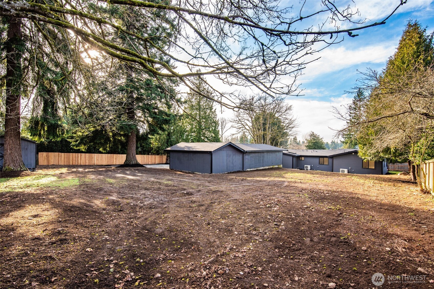 4922 Northeast 20th Place Renton, WA 98059 - Photo 26 of 38 a backyard of a house with large trees