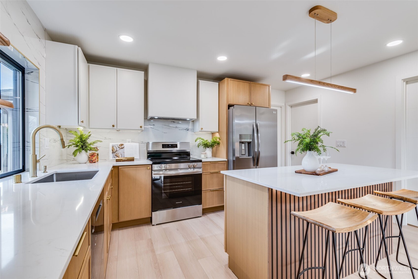 4922 Northeast 20th Place Renton, WA 98059 - Photo 6 of 38 a kitchen with stainless steel appliances granite countertop a stove a refrigerator a sink a dining table and chairs with wooden floor