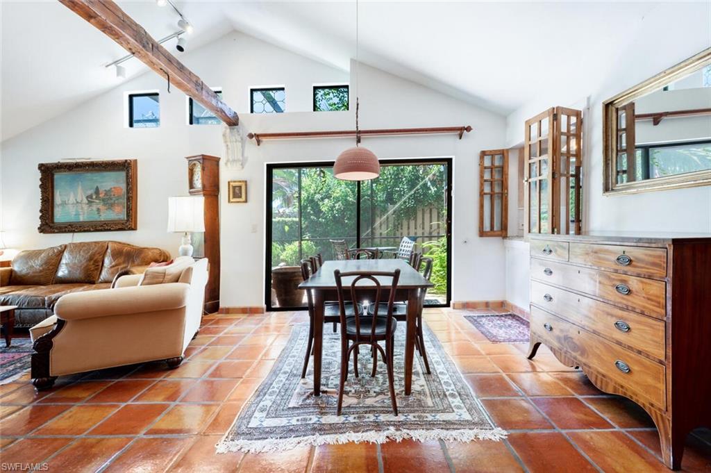 839 Reef Point Circle, Unit 41 Naples, FL 34108 - Photo 11 of 37 a living room with furniture a large window and dining table