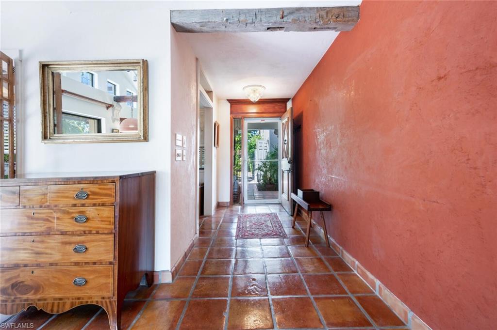 839 Reef Point Circle, Unit 41 Naples, FL 34108 - Photo 13 of 37 a hallway with front door wooden floor and windows