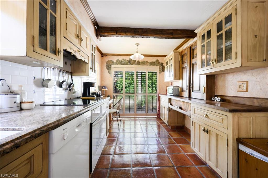 839 Reef Point Circle, Unit 41 Naples, FL 34108 - Photo 15 of 37 a kitchen with stainless steel appliances granite countertop a stove a sink and a microwave