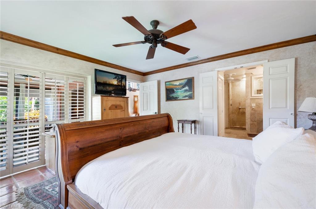 839 Reef Point Circle, Unit 41 Naples, FL 34108 - Photo 19 of 37 a bedroom with a large bed and a large window