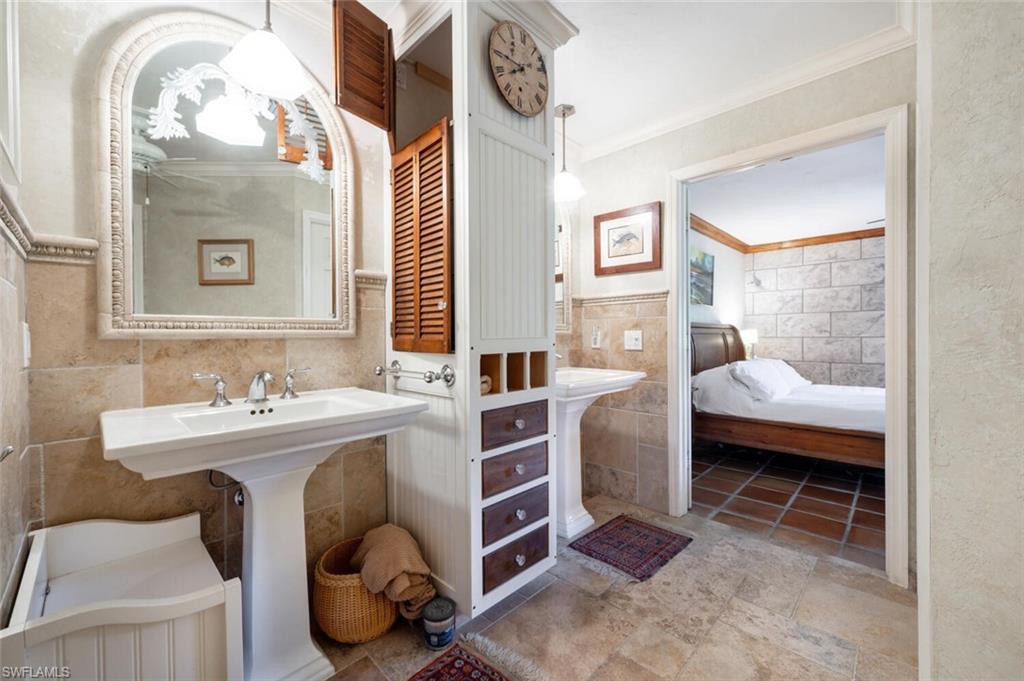 839 Reef Point Circle, Unit 41 Naples, FL 34108 - Photo 21 of 37 a bathroom with a sink and a mirror