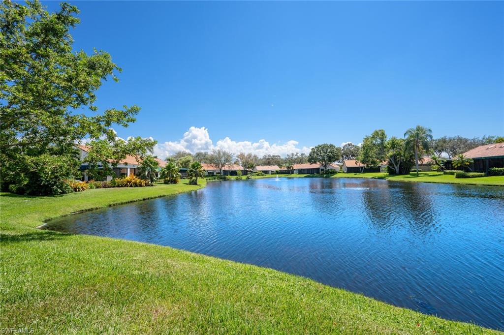 839 Reef Point Circle, Unit 41 Naples, FL 34108 - Photo 25 of 37 a view of a lake with houses in the back