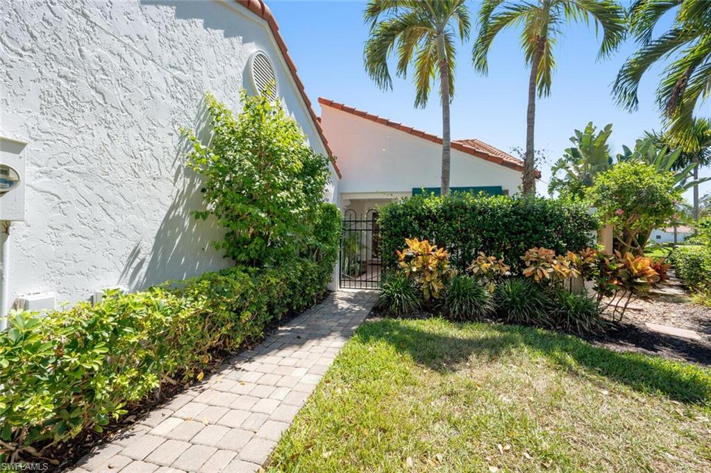 839 Reef Point Circle, Unit 41 Naples, FL 34108 - Photo 4 of 37 a view of a garden with a pathway