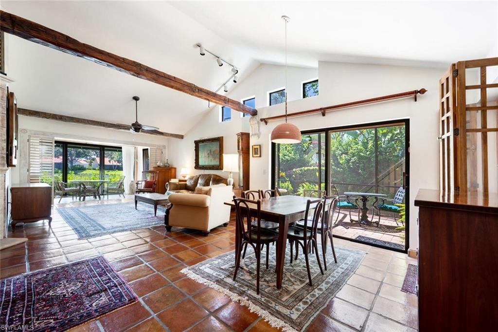 839 Reef Point Circle, Unit 41 Naples, FL 34108 - Photo 6 of 37 a living room with patio furniture and a large window