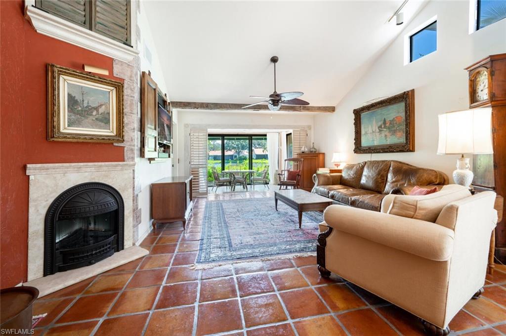 839 Reef Point Circle, Unit 41 Naples, FL 34108 - Photo 7 of 37 a living room with furniture a rug and a fireplace