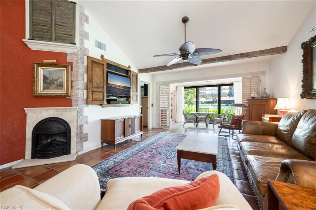 839 Reef Point Circle, Unit 41 Naples, FL 34108 - Photo 8 of 37 a living room with furniture a fireplace and a flat screen tv