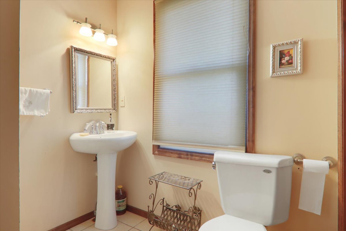 2215 Woodfield Road Bloomington, IL 61704 - Photo 11 of 35 a bathroom with a sink a toilet and shower