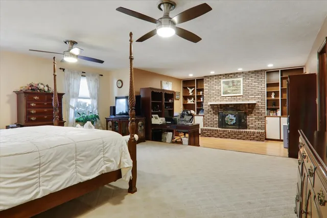 a bedroom with a bed and a fireplace