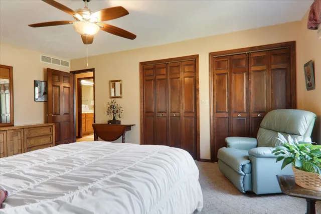 a bedroom with a balcony a bed and a chandelier