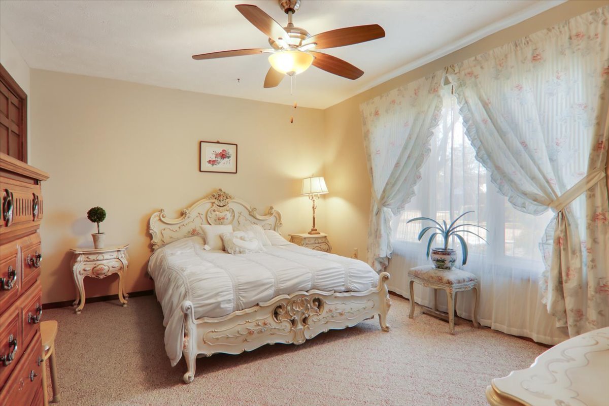 2215 Woodfield Road Bloomington, IL 61704 - Photo 18 of 35 a bedroom with a bed and a chandelier