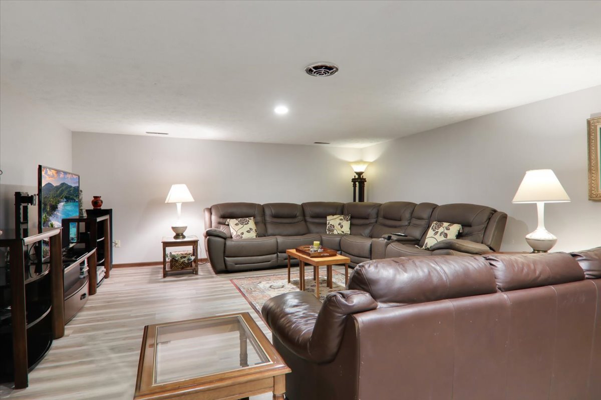 2215 Woodfield Road Bloomington, IL 61704 - Photo 19 of 35 a living room with furniture and a flat screen tv