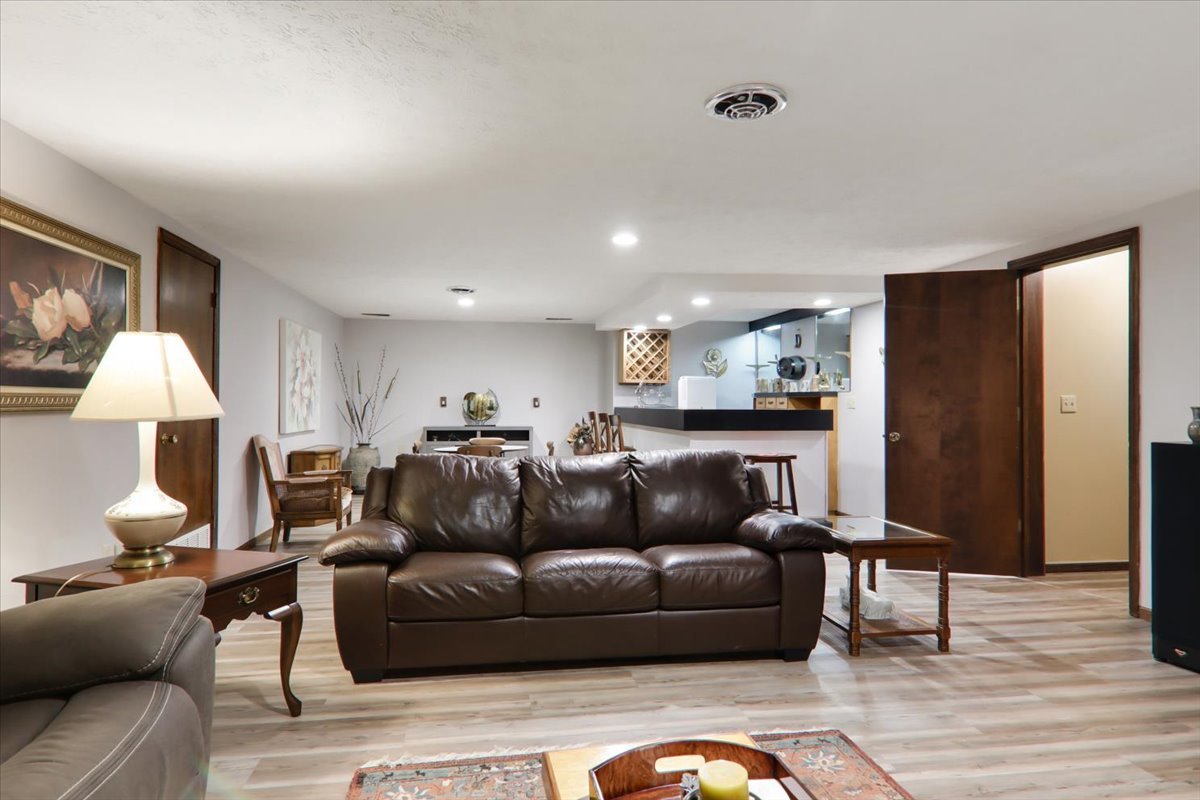 2215 Woodfield Road Bloomington, IL 61704 - Photo 20 of 35 a living room with furniture and a lamp