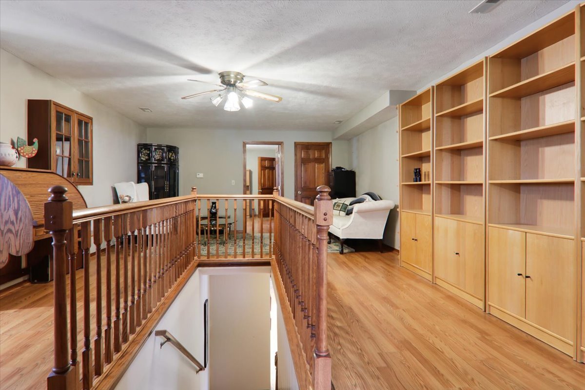 2215 Woodfield Road Bloomington, IL 61704 - Photo 26 of 35 a view of a bedroom with furniture and staircase