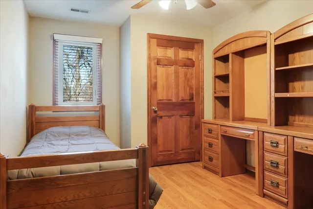 a bedroom with a bed and a window