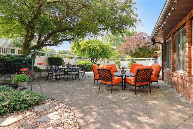 a view of a patio with table and chairs and potted plants