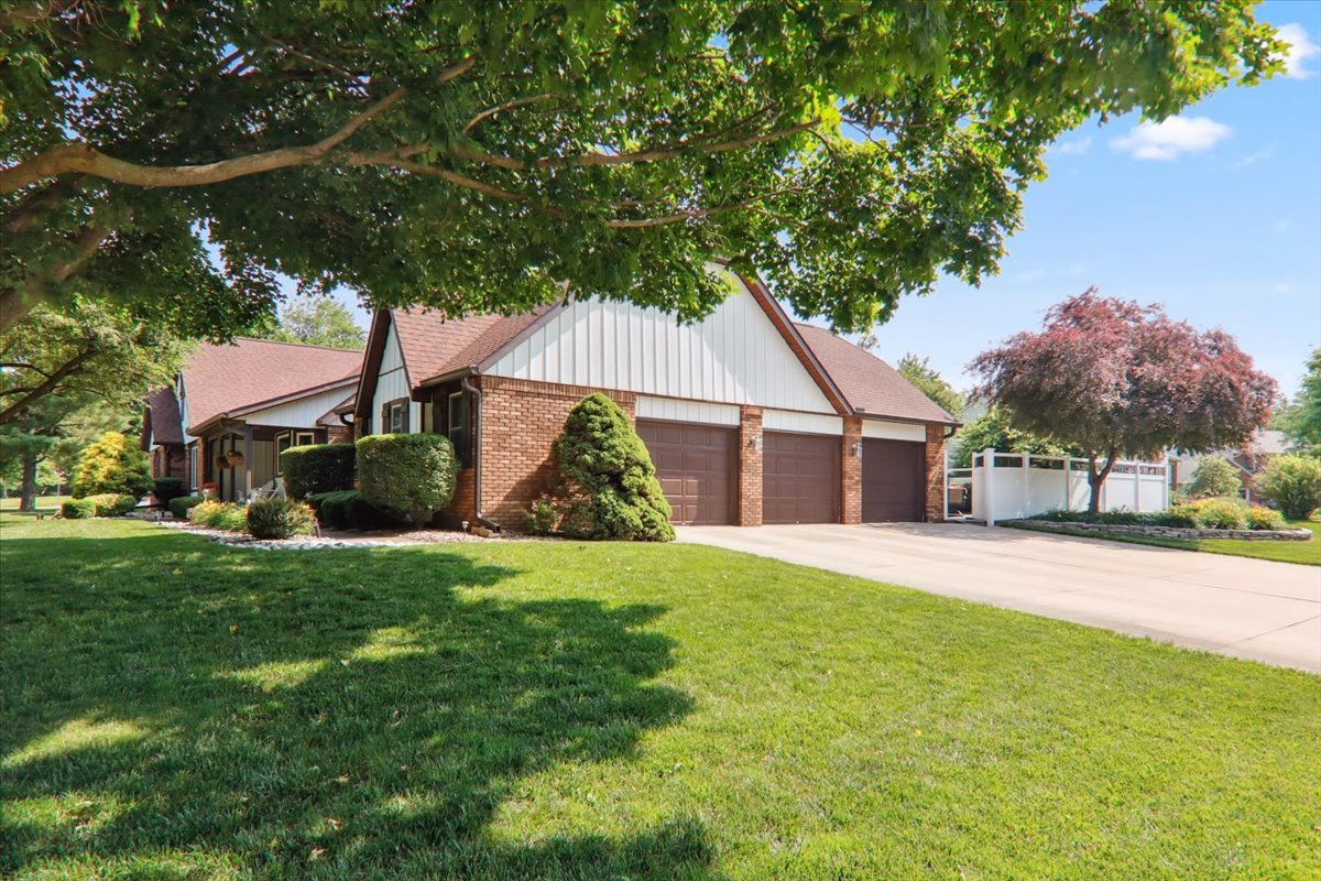 2215 Woodfield Road Bloomington, IL 61704 - Photo 31 of 35 a view of a house with a yard and palm trees