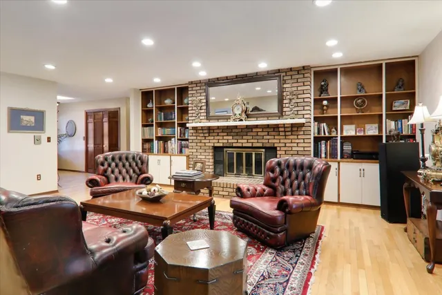 a living room with furniture a rug and a fireplace