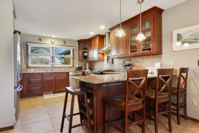 a kitchen with a table and chairs in it