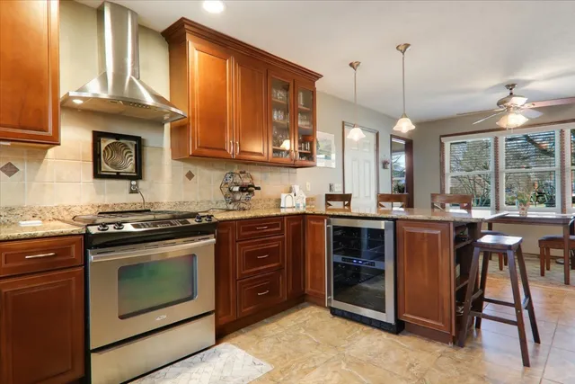 a kitchen with a stove window and cabinets