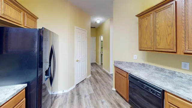 a kitchen with stainless steel appliances granite countertop a refrigerator and a sink