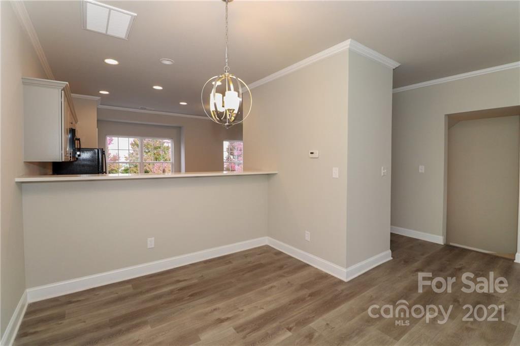 1265 Amber Ridge Road Northwest Concord, NC 28027 - Photo 13 of 26 an empty room with wooden floor and windows