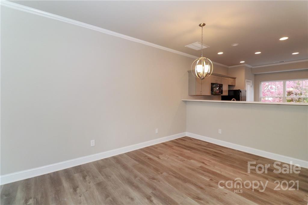 1265 Amber Ridge Road Northwest Concord, NC 28027 - Photo 14 of 26 an empty room with wooden floor and windows