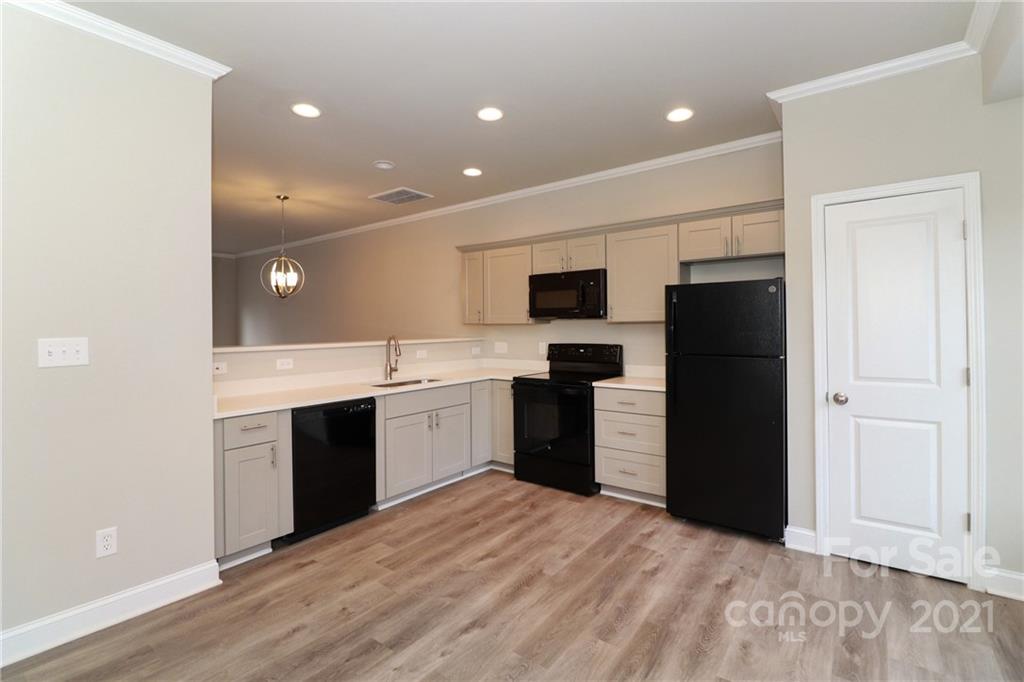 1265 Amber Ridge Road Northwest Concord, NC 28027 - Photo 16 of 26 a large kitchen with a refrigerator and a stove top oven
