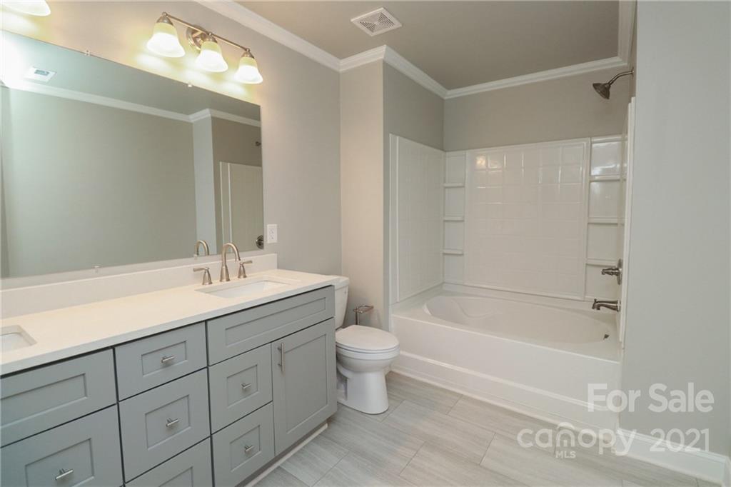 1265 Amber Ridge Road Northwest Concord, NC 28027 - Photo 21 of 26 a bathroom with a sink a toilet and shower