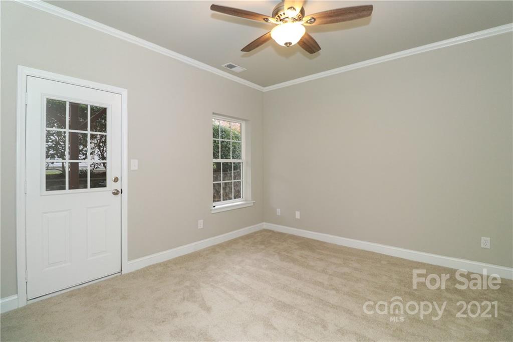 1265 Amber Ridge Road Northwest Concord, NC 28027 - Photo 5 of 26 an empty room with windows and fan