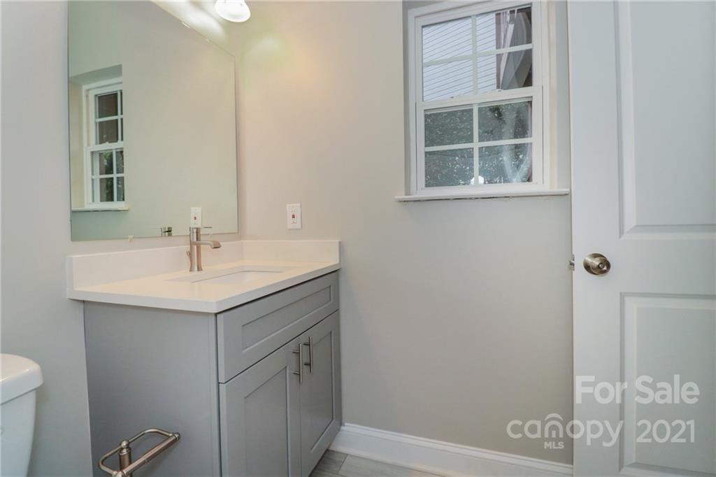 1265 Amber Ridge Road Northwest Concord, NC 28027 - Photo 7 of 26 a bathroom with a sink a vanity and a shower