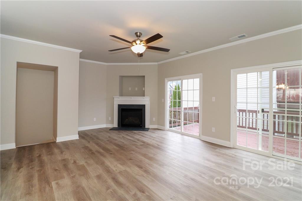 1265 Amber Ridge Road Northwest Concord, NC 28027 - Photo 10 of 26 a view of empty room with wooden floor and fan
