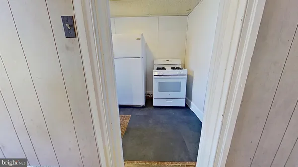 a view of a room with wooden floor and a window