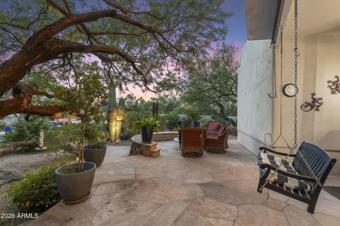 a outdoor sitting area with furniture and wooden floor