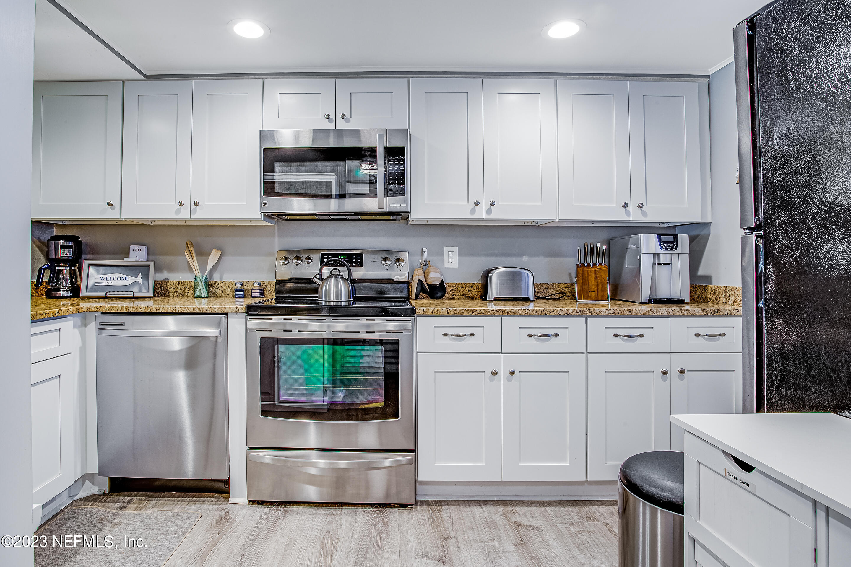 4 Ocean Trace Road, Unit 224 St. Augustine, FL 32080 - Photo 2 of 36 a kitchen with white cabinets and stainless steel appliances
