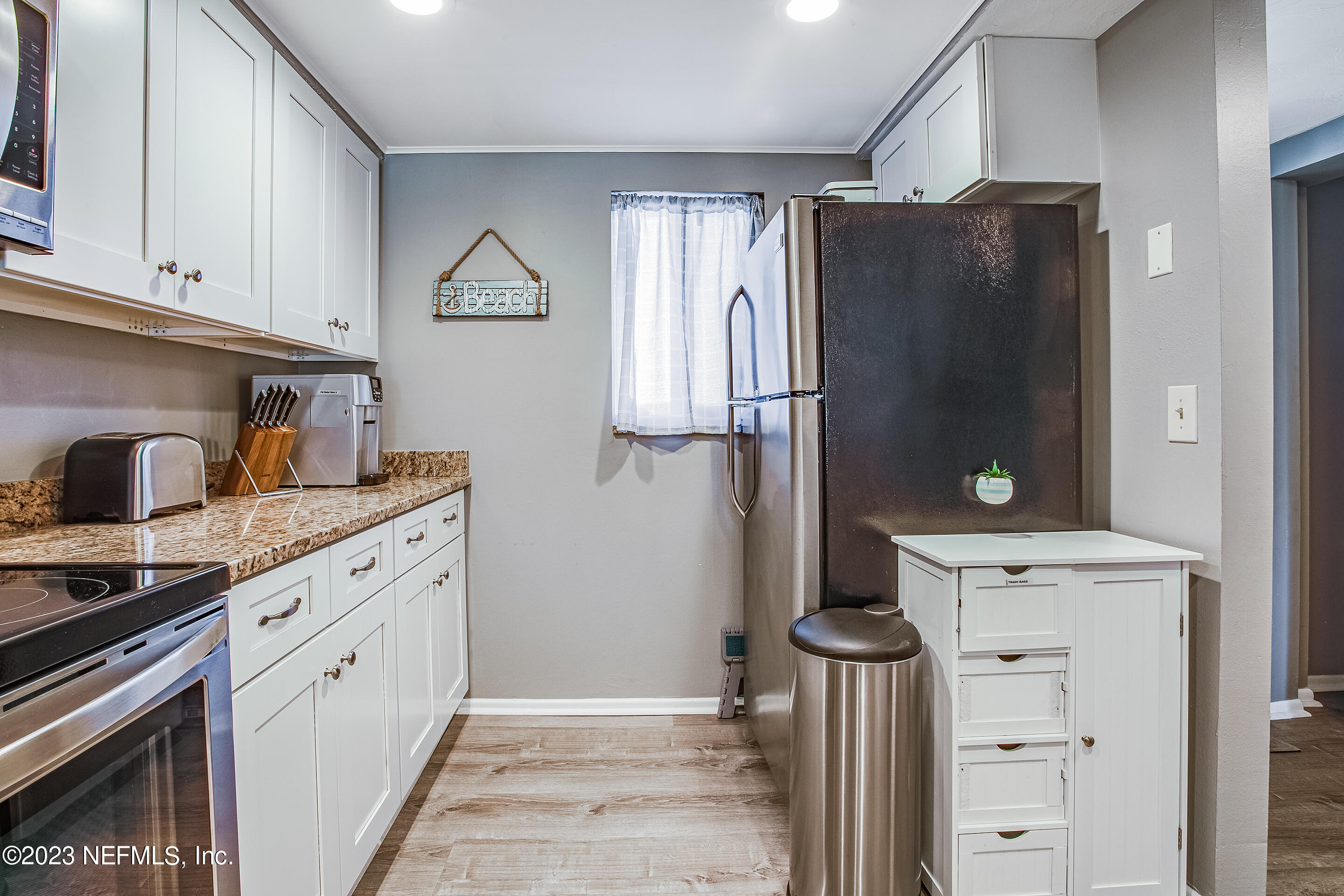 4 Ocean Trace Road, Unit 224 St. Augustine, FL 32080 - Photo 3 of 36 a kitchen with a refrigerator and cabinets