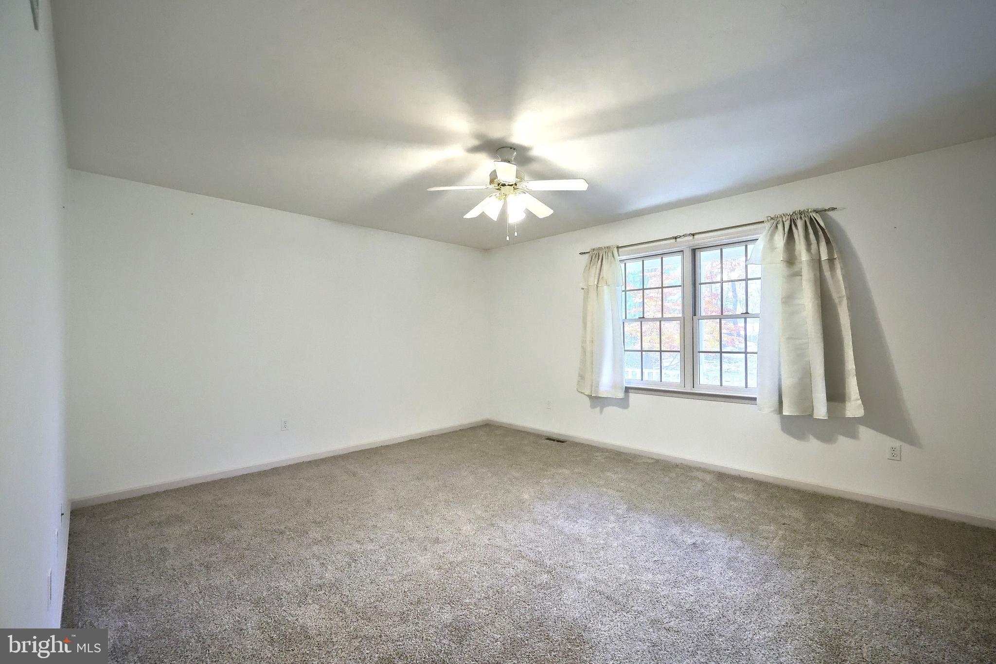 65 Scarlet Way Biglerville, PA 17307 - Photo 14 of 34 an empty room with windows and chandelier fan