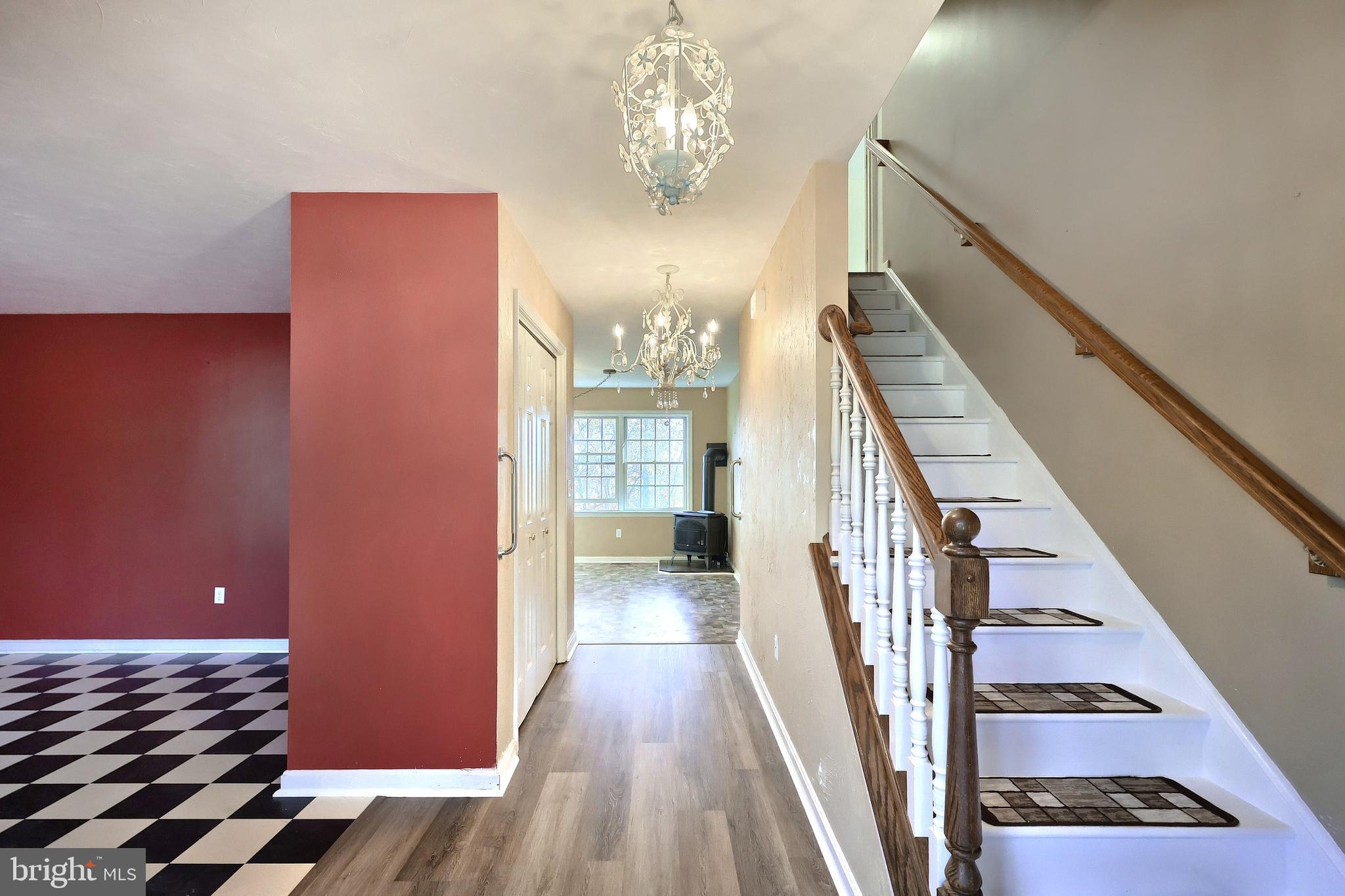 65 Scarlet Way Biglerville, PA 17307 - Photo 5 of 34 a view of a hallway with wooden floor and staircase