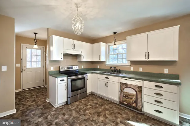 a kitchen with a stove a sink and a refrigerator