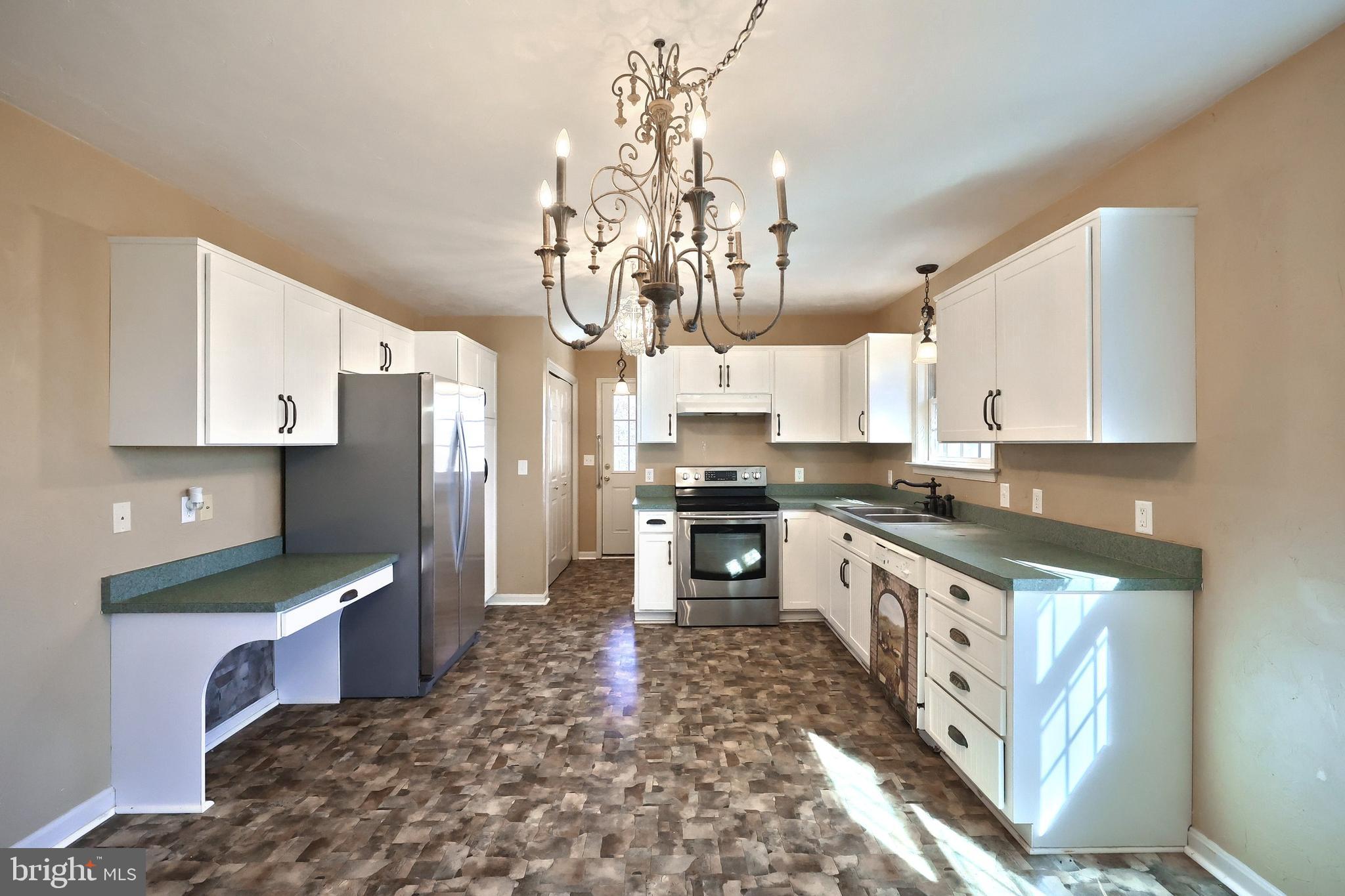 65 Scarlet Way Biglerville, PA 17307 - Photo 9 of 34 a large kitchen with stainless steel appliances kitchen island granite countertop a sink and cabinets