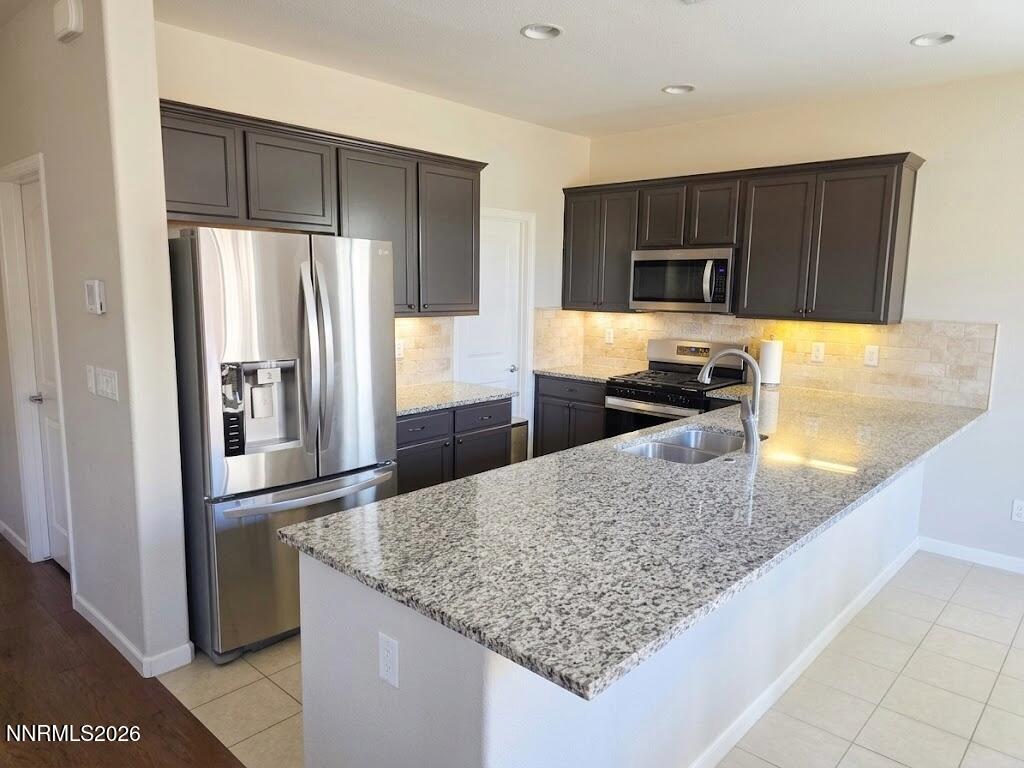 2775 Bonfire Lane Reno, NV 89521 - Photo 15 of 41 a kitchen with stainless steel appliances granite countertop a refrigerator and a sink