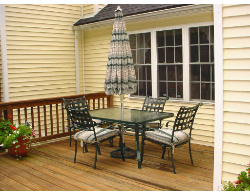 31 Cold Spring Drive, Unit C Sutton, MA 01590 - Photo 17 of 20 a patio with table and chairs and potted plants
