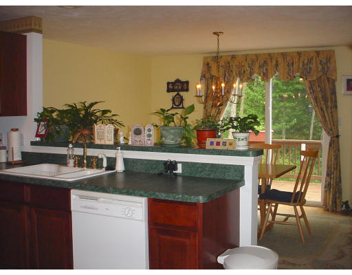 31 Cold Spring Drive, Unit C Sutton, MA 01590 - Photo 9 of 20 a kitchen with stainless steel appliances granite countertop a sink and a table