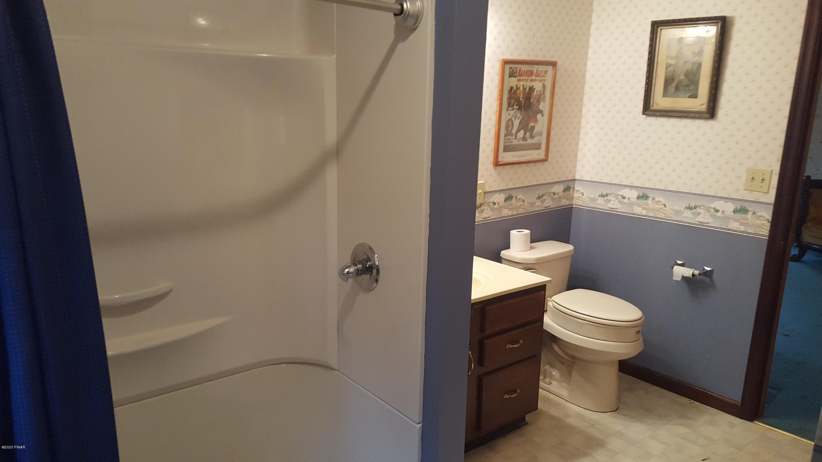 554 St Tikhons Road Waymart, PA 18472 - Photo 7 of 29 a white toilet sitting next to a bathroom sink