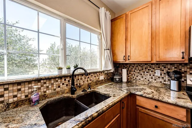 a kitchen with a sink and large window
