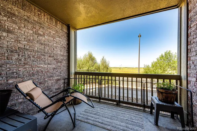 a view of a balcony with wooden floor