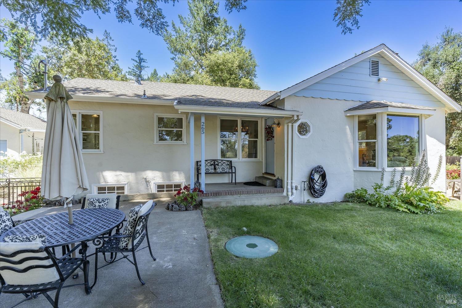 a view of a house with backyard sitting area and garden