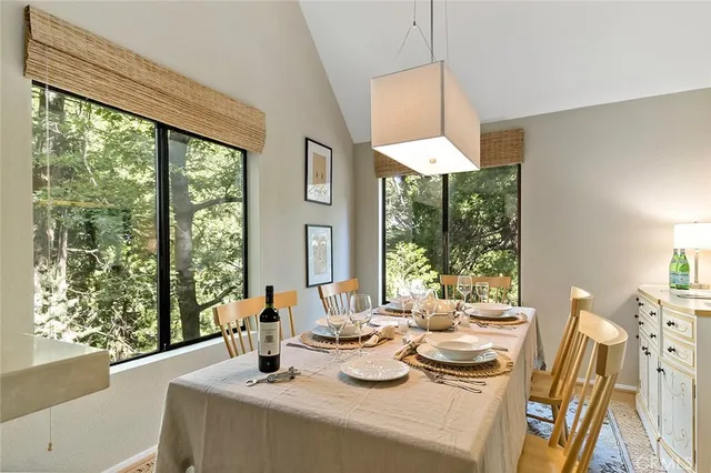 a dining room with furniture window wooden floor and a chandelier